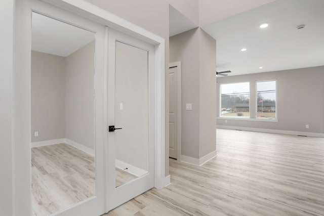 hall featuring baseboards, wood finished floors, and recessed lighting