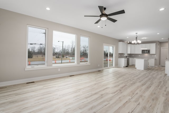 unfurnished living room featuring recessed lighting, visible vents, and baseboards