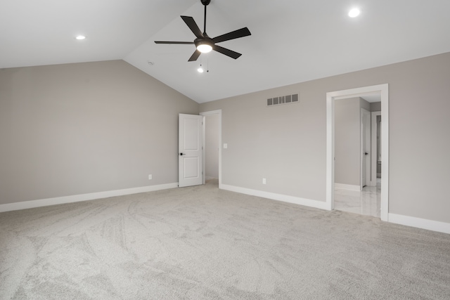 unfurnished bedroom featuring lofted ceiling, recessed lighting, light carpet, visible vents, and baseboards