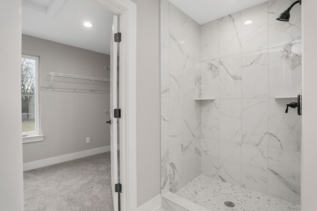 bathroom with recessed lighting, baseboards, and a marble finish shower