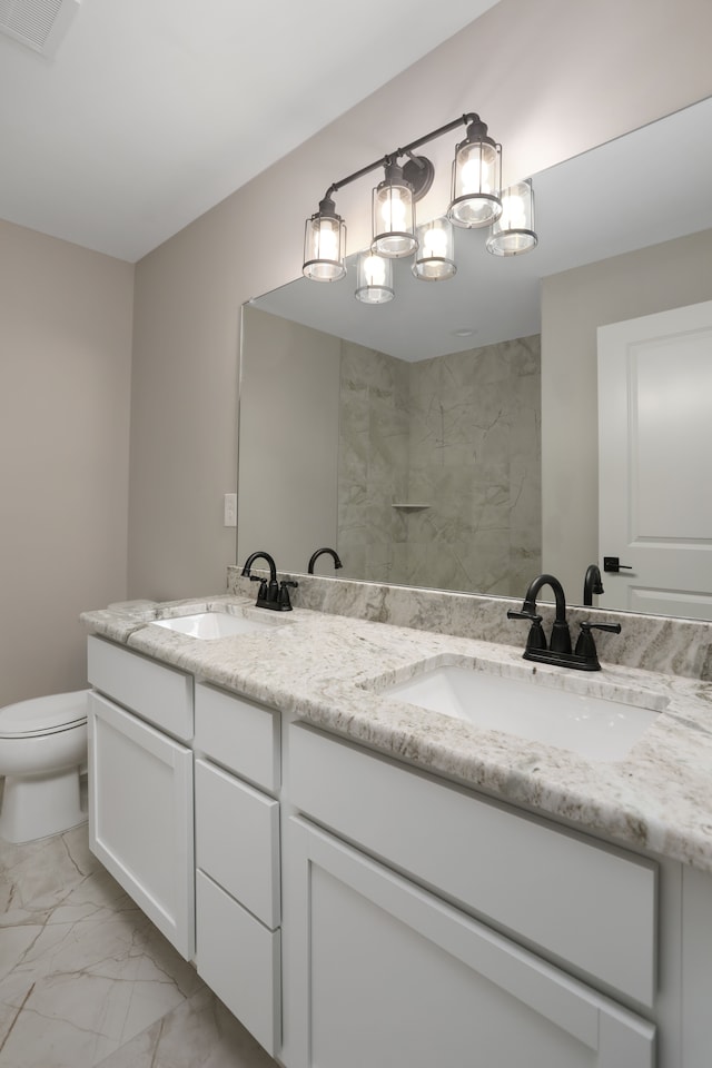 bathroom featuring marble finish floor, visible vents, a sink, and toilet