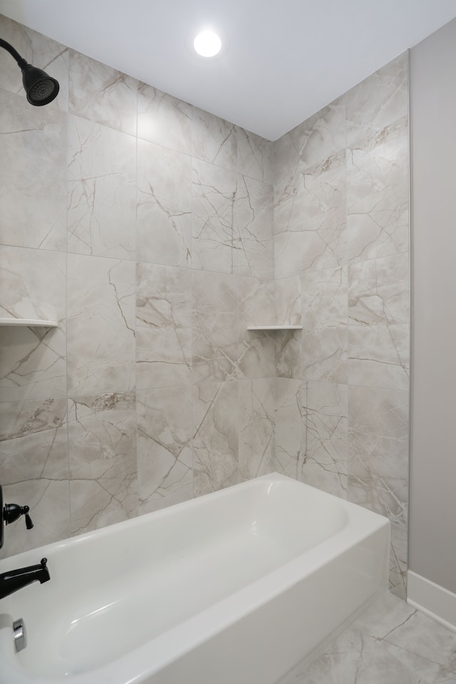 bathroom with marble finish floor and shower / bathing tub combination