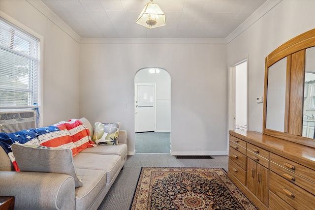 living room featuring carpet, cooling unit, and crown molding