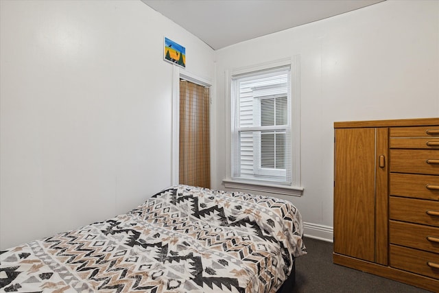 bedroom with dark colored carpet