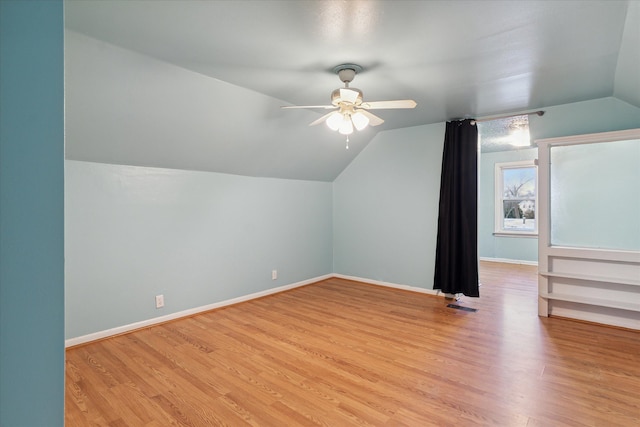 additional living space featuring light wood-type flooring, vaulted ceiling, and ceiling fan