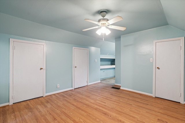 additional living space with ceiling fan, light hardwood / wood-style floors, and vaulted ceiling