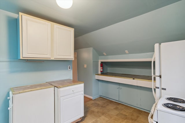 kitchen featuring white appliances, white cabinetry, and lofted ceiling