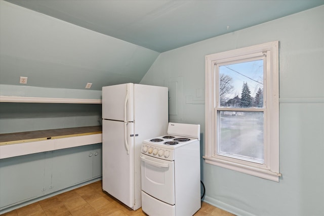 kitchen featuring lofted ceiling and white appliances