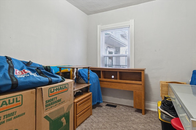 carpeted bedroom featuring a textured ceiling