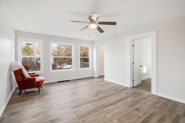 interior space featuring light wood-type flooring and ceiling fan