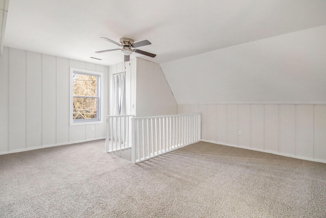 additional living space featuring lofted ceiling, carpet floors, and ceiling fan