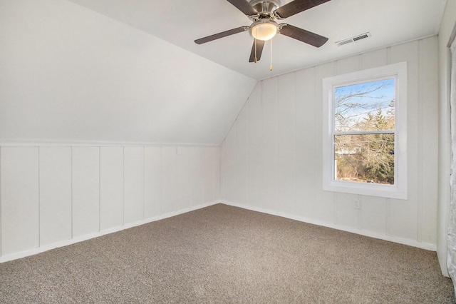 additional living space featuring ceiling fan, lofted ceiling, and carpet flooring