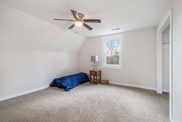 carpeted bedroom featuring ceiling fan and vaulted ceiling