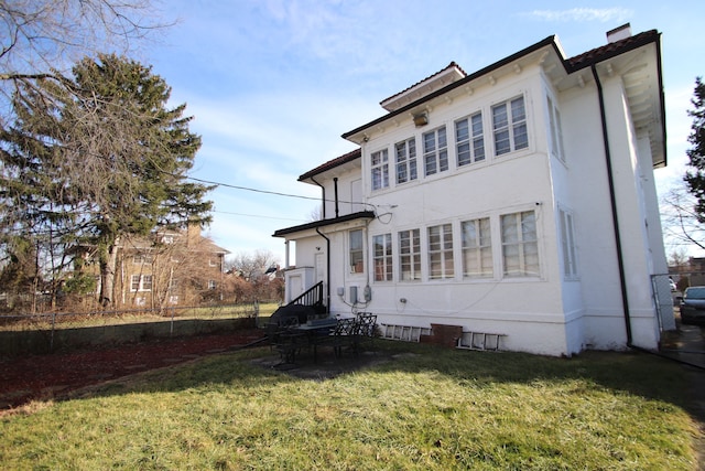 back of house with a yard