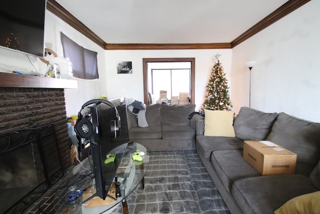 living room with crown molding and a brick fireplace