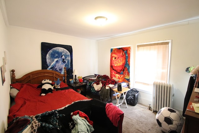 bedroom with carpet flooring, multiple windows, crown molding, and radiator heating unit