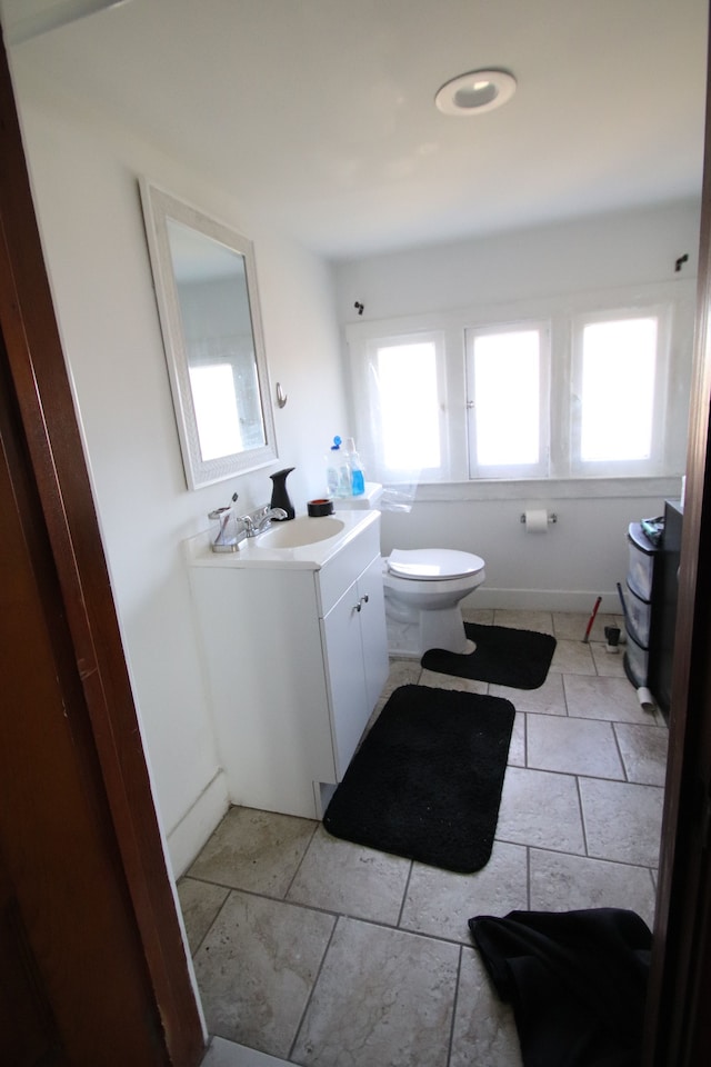 bathroom with tile patterned floors, vanity, and toilet