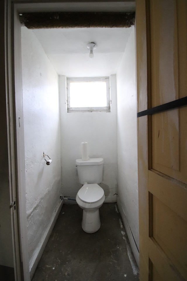 bathroom featuring toilet and concrete flooring