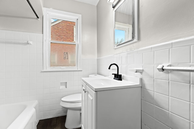 bathroom with hardwood / wood-style floors, vanity, toilet, and tile walls