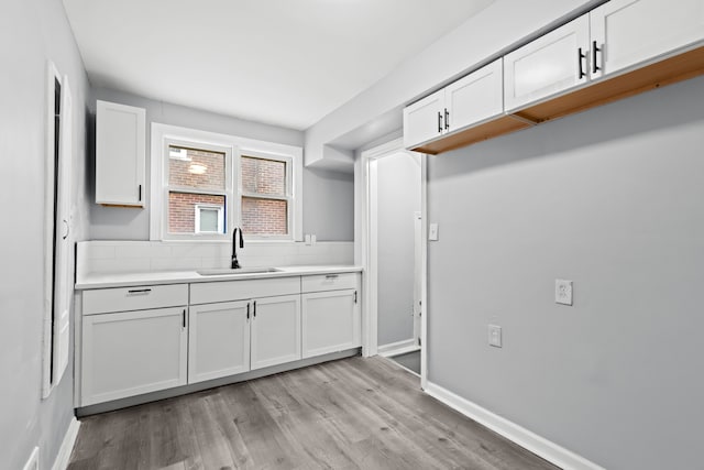 kitchen featuring sink, white cabinets, and light hardwood / wood-style floors