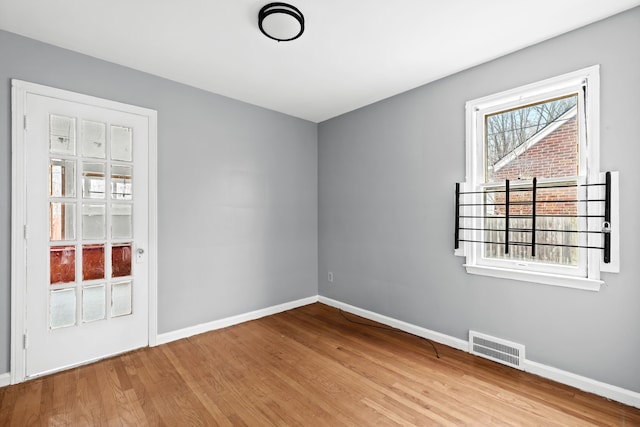 spare room featuring light hardwood / wood-style floors