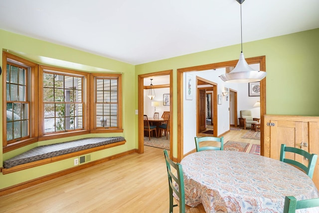 dining space with light hardwood / wood-style floors