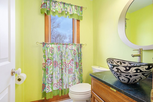 bathroom featuring vanity and toilet