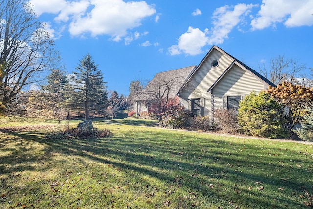 view of side of property with a yard