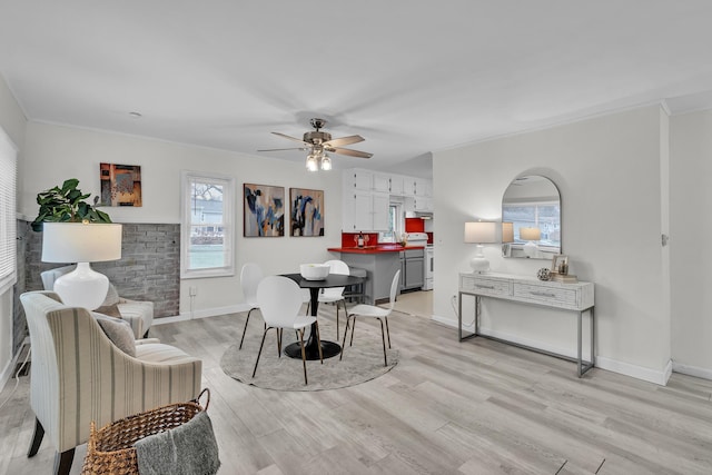 dining area featuring light hardwood / wood-style floors, ceiling fan, and ornamental molding