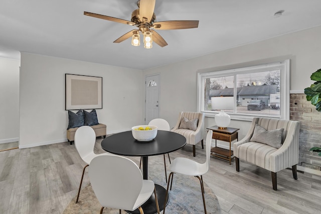 dining area with ceiling fan and light hardwood / wood-style floors