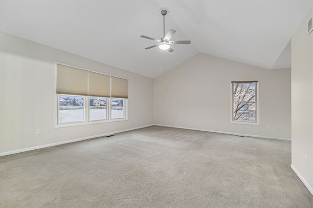 carpeted empty room featuring ceiling fan and lofted ceiling