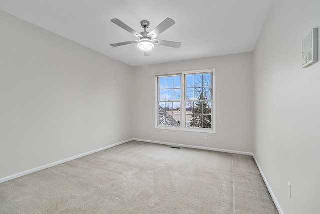 empty room featuring light carpet and ceiling fan