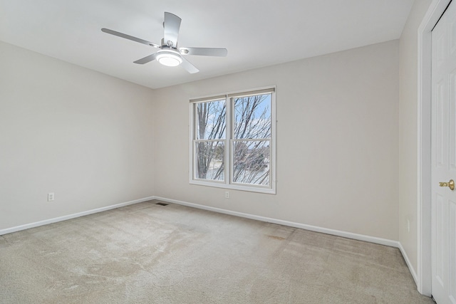 carpeted spare room with ceiling fan