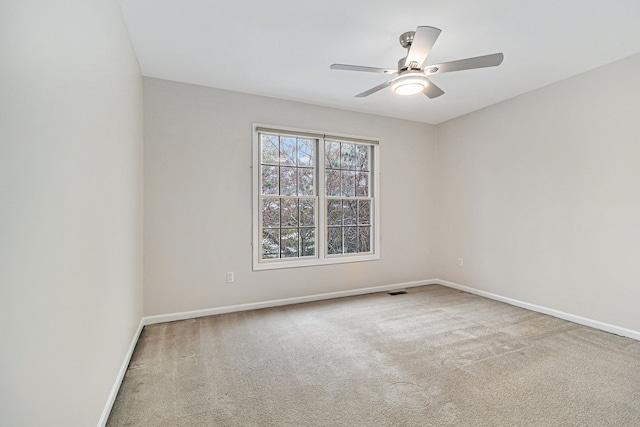 unfurnished room with ceiling fan and carpet floors