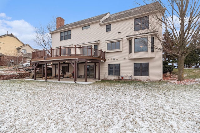 back of house featuring a deck and a patio