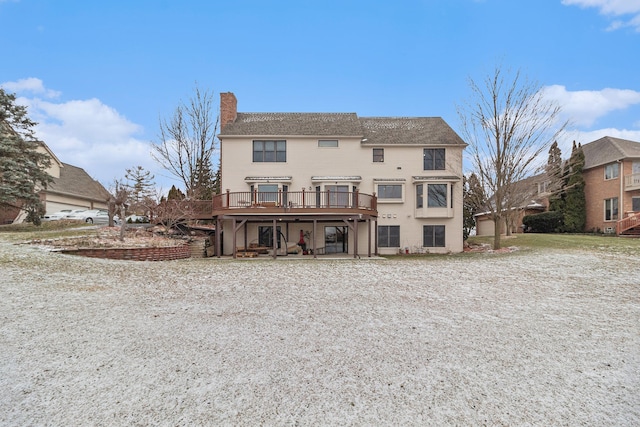 rear view of property featuring a deck