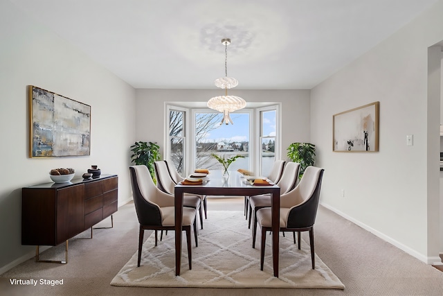 carpeted dining space with a notable chandelier