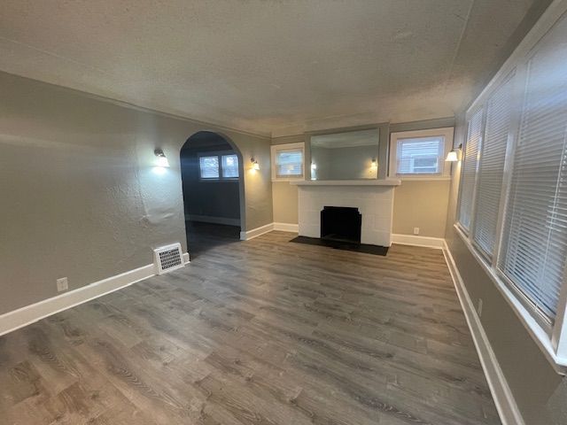 unfurnished living room featuring dark hardwood / wood-style floors