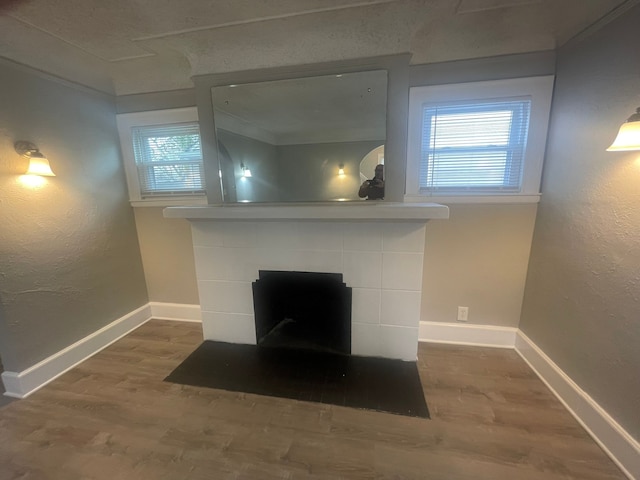 room details with a fireplace, wood-type flooring, and ornamental molding