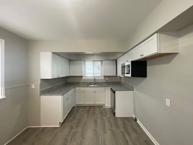 kitchen with sink, white cabinets, stainless steel appliances, and dark hardwood / wood-style floors