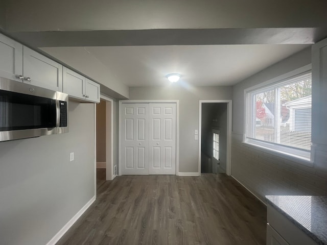 interior space featuring white cabinets and dark hardwood / wood-style floors