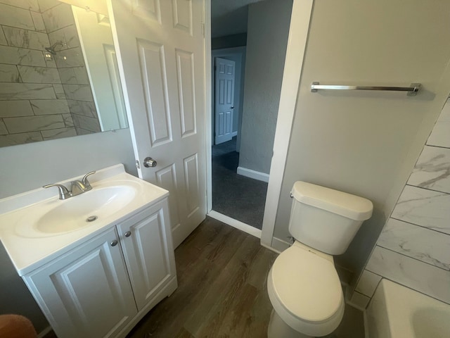 bathroom with vanity, toilet, and wood-type flooring