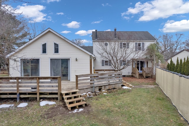 back of property with a yard and a deck