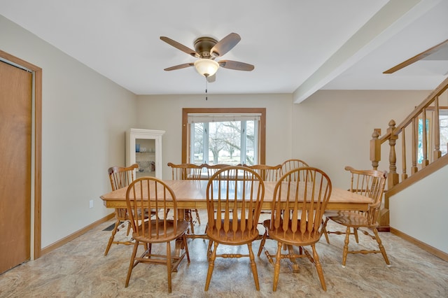 dining space with ceiling fan and beam ceiling