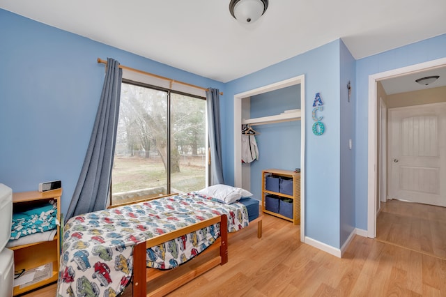 bedroom featuring a closet and light hardwood / wood-style flooring