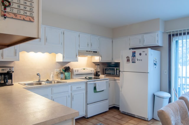 kitchen with white appliances, white cabinetry, and sink