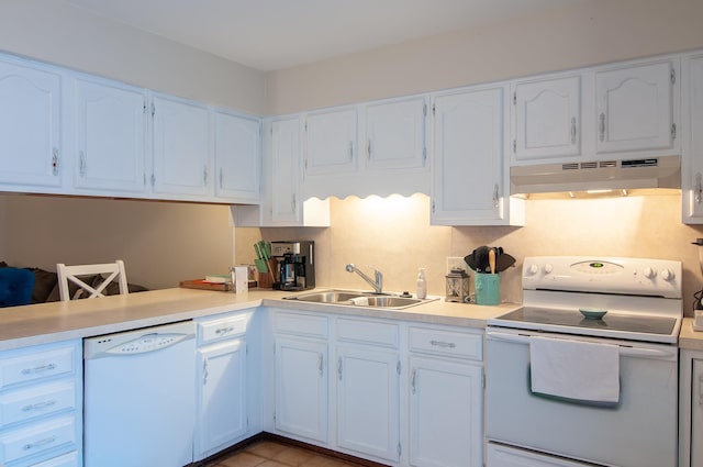 kitchen with white appliances, white cabinetry, and sink