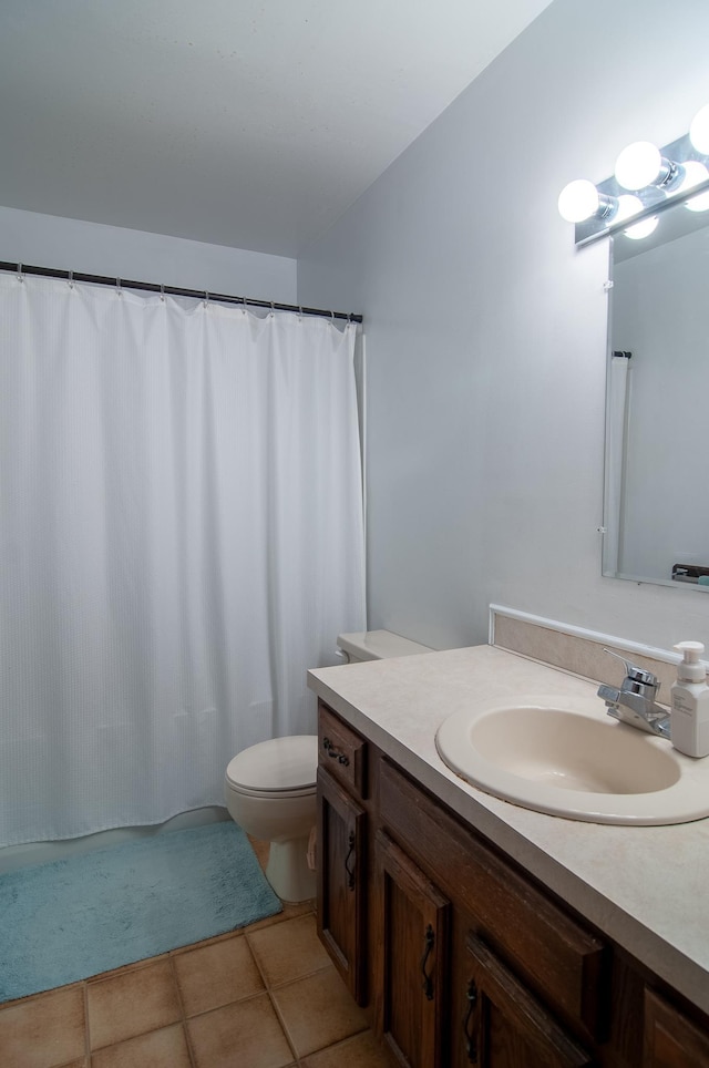 bathroom featuring tile patterned floors, vanity, and toilet