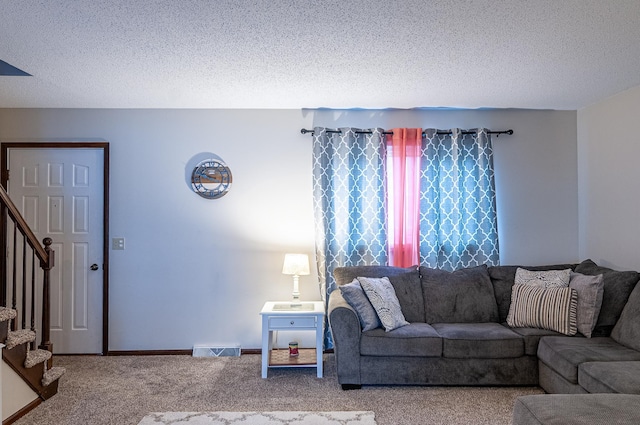 living room with carpet and a textured ceiling