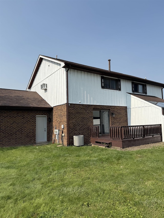 381 Kleiner St, Frankenmuth, MI 48734 - back of property featuring brick siding, a lawn, central AC unit, board and batten siding, and a wooden deck
